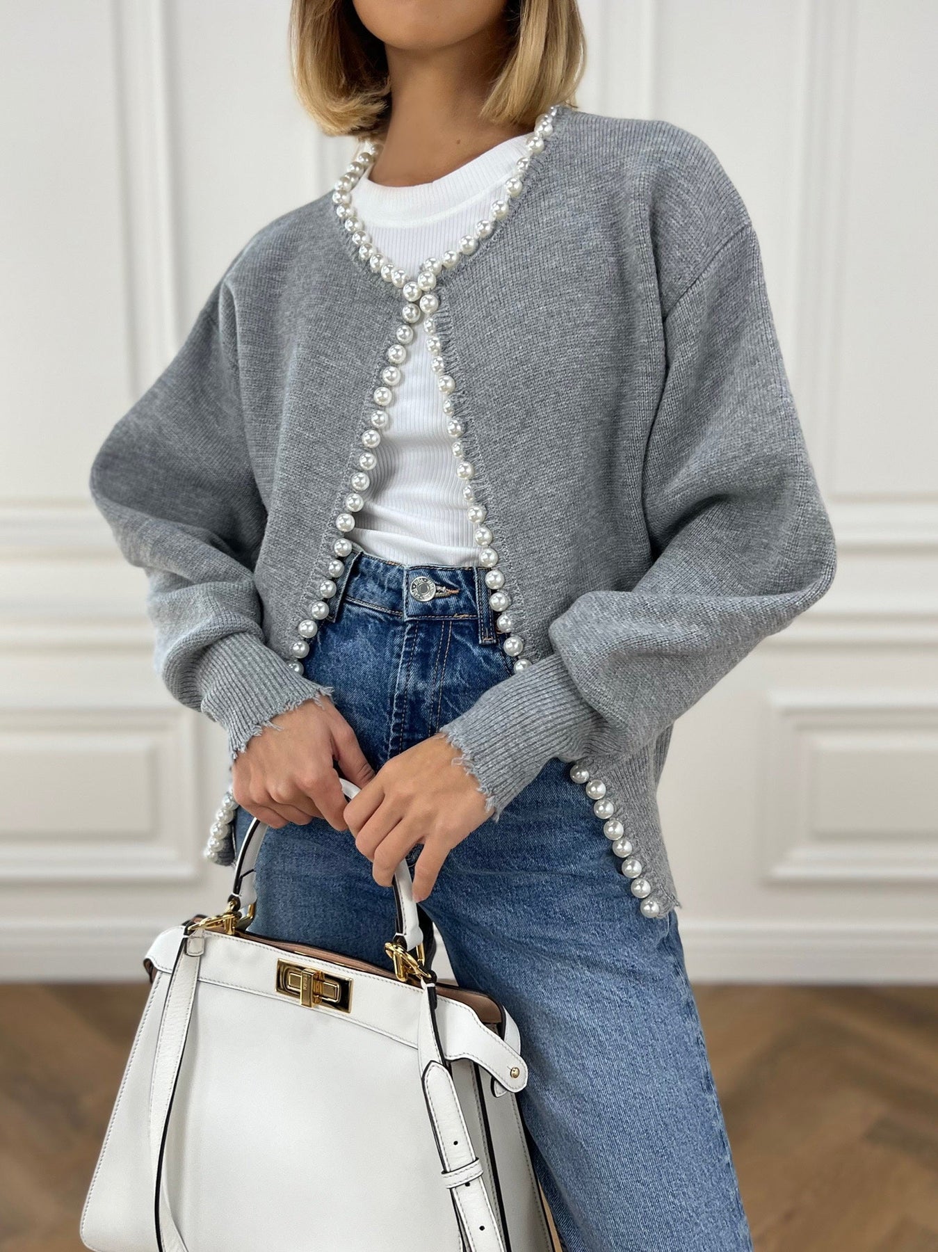 Women's grey knit cardigan with open front and pearl button trim, relaxed fit