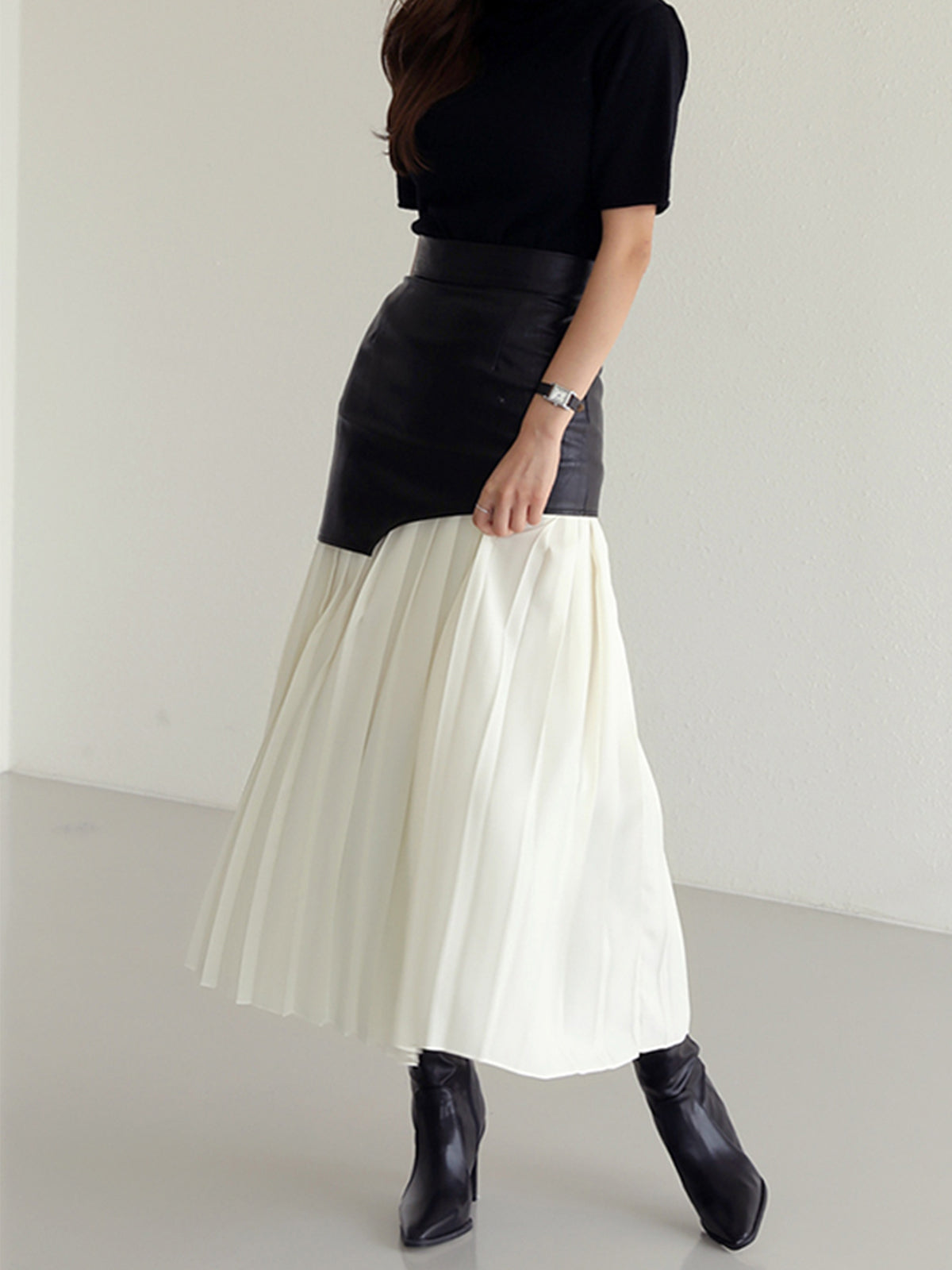 Black-and-white leather maxi skirt with asymmetrical yoke and pleated white panel