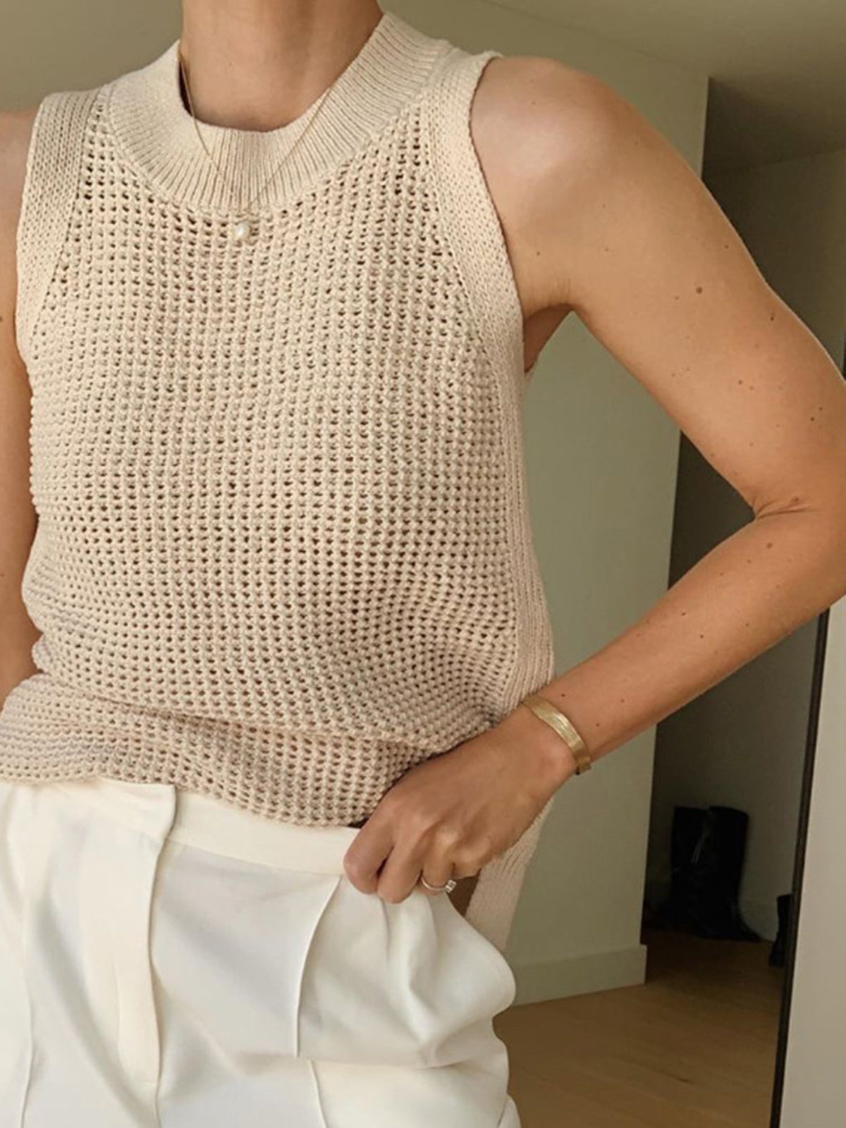 Cream open-knit cotton sleeveless tank with ribbed crew neck and textured crochet pattern