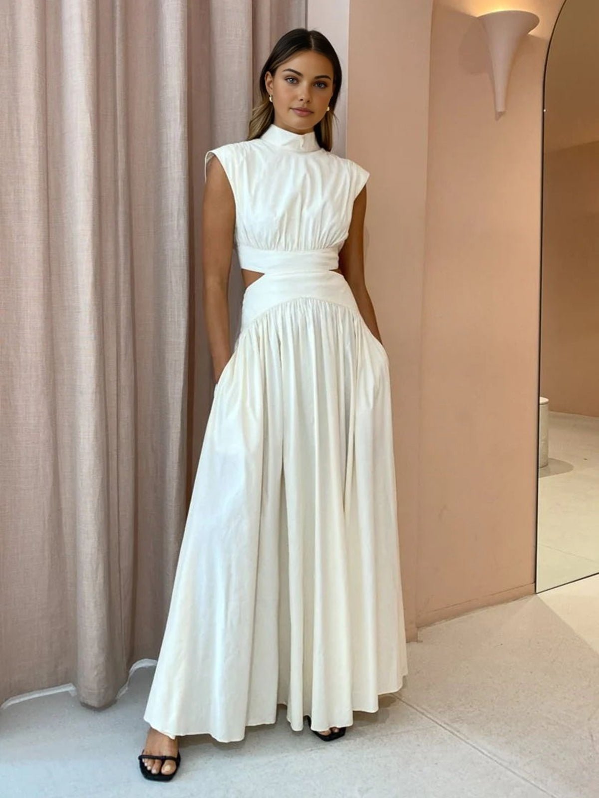 White sleeveless mock-neck maxi dress with ruched bodice and gathered skirt