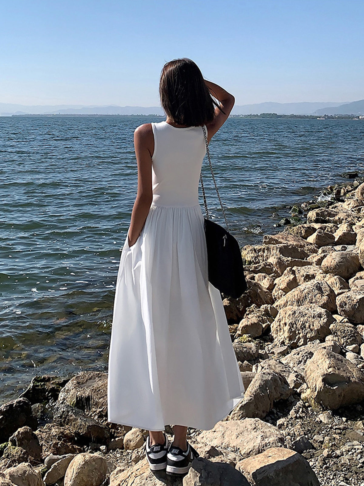 White cotton sleeveless midi dress, back view, ribbed bodice with gathered skirt