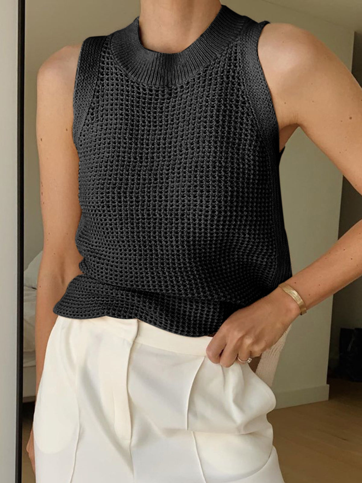 Black open-knit cotton sleeveless tank top with ribbed crew neckline and crochet mesh texture