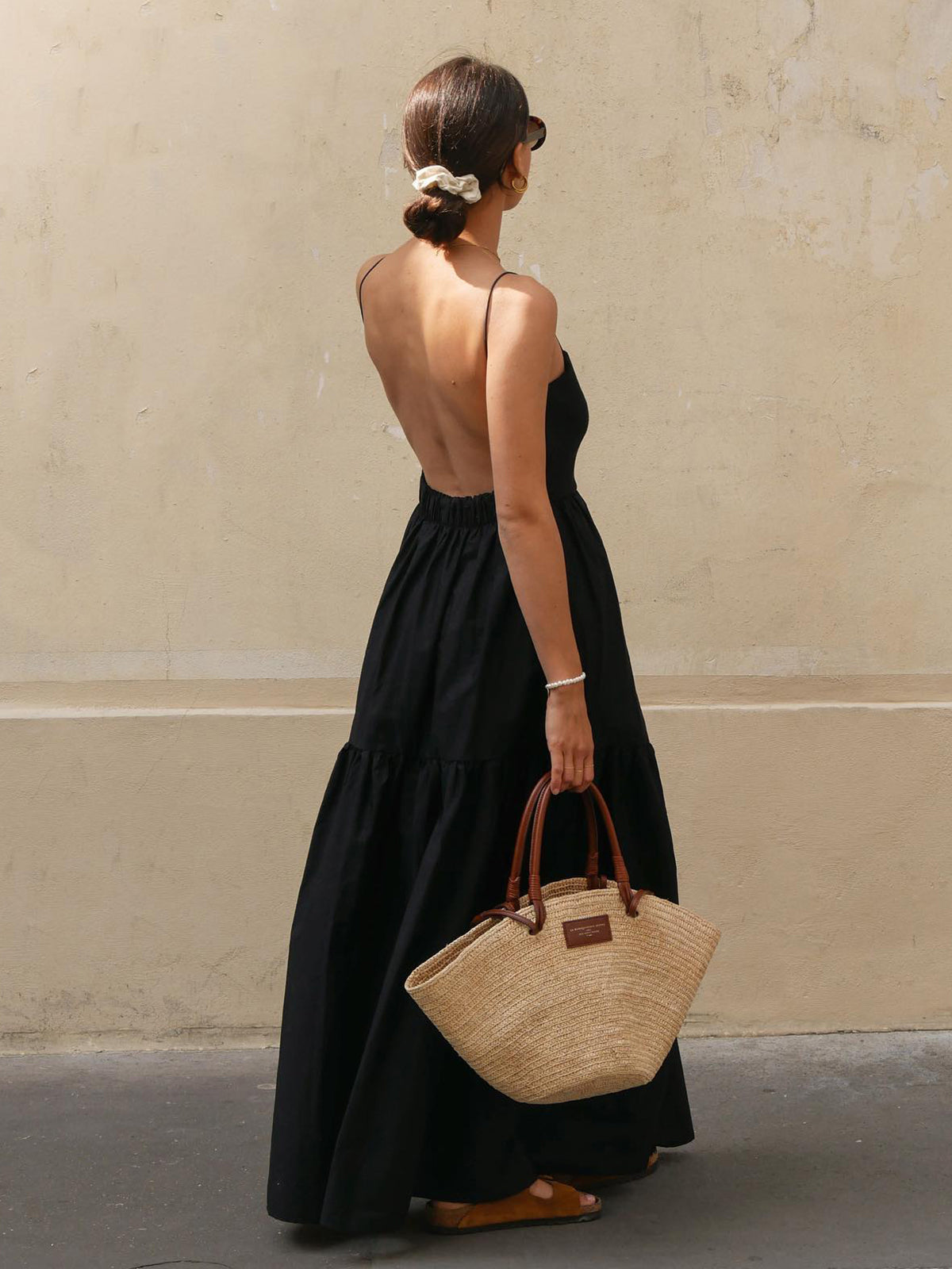 Black backless long dress with spaghetti straps and tiered skirt, open back