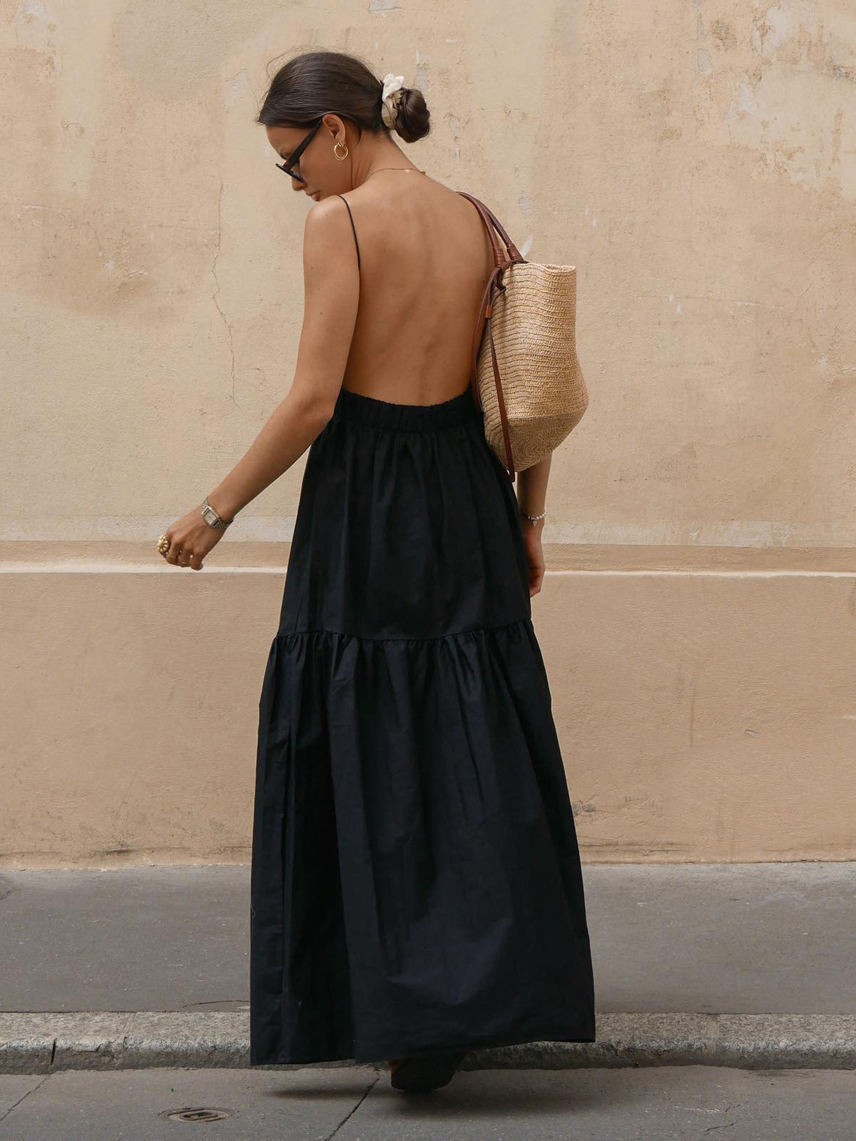 Black backless long dress with open back, spaghetti straps, and tiered ruffles