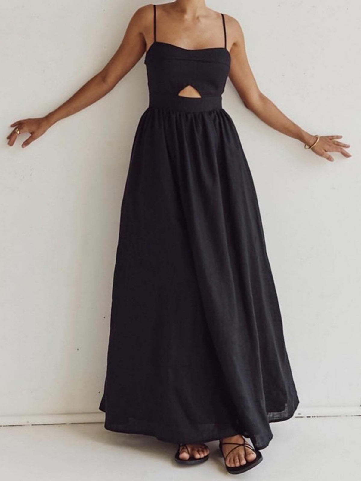 Black A-line maxi dress with spaghetti straps and cutout waist, full gathered skirt