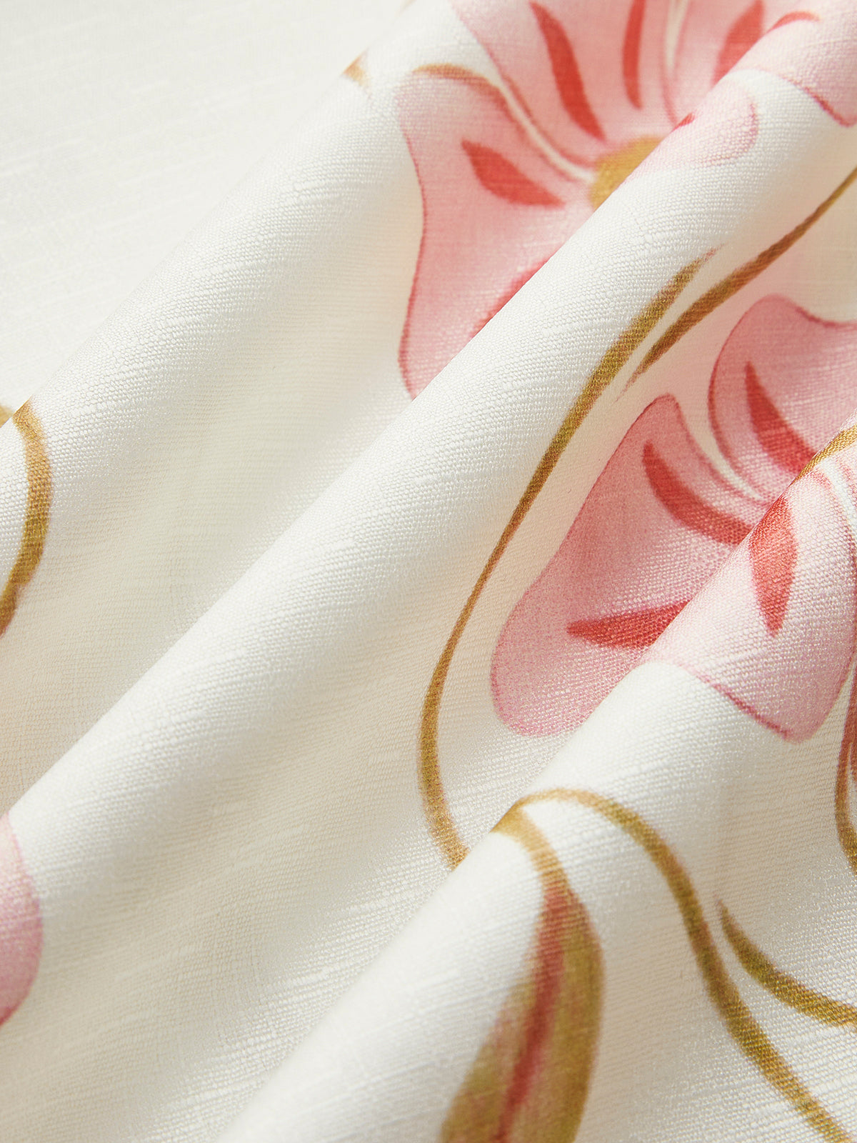 White linen fabric with pink and gold floral vine pattern