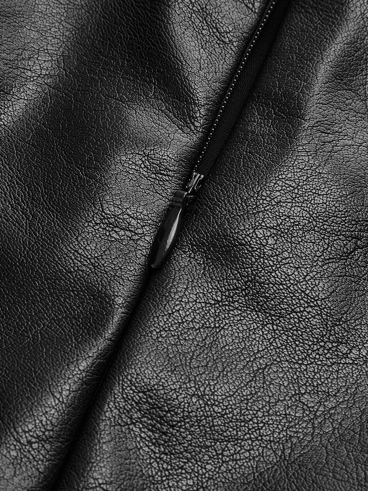 Close-up of black leather fabric texture with stitched seam detail