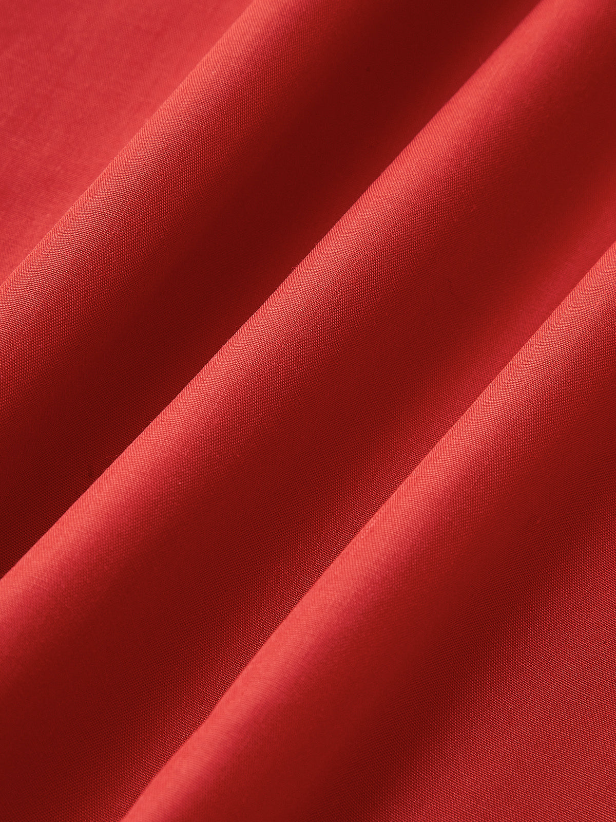 Red woven fabric close-up with soft sheen texture