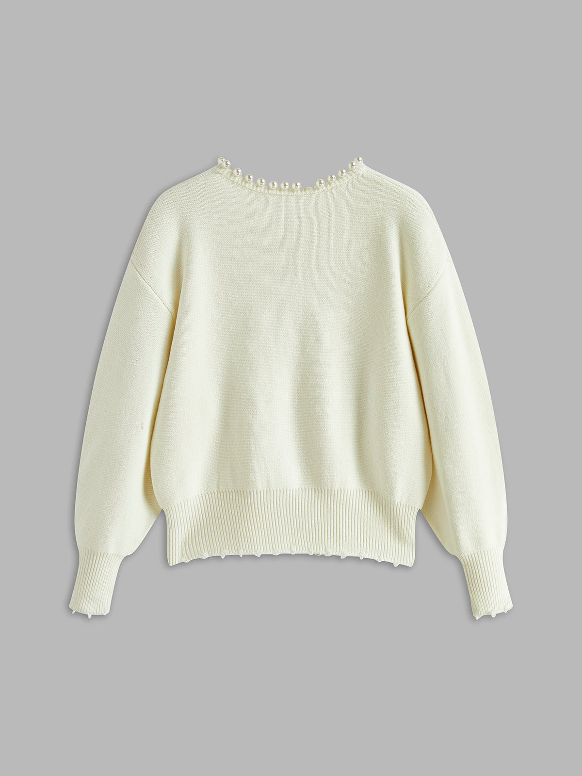 Cream knit cardigan with ribbed hem and sleeves, open-front style in back view