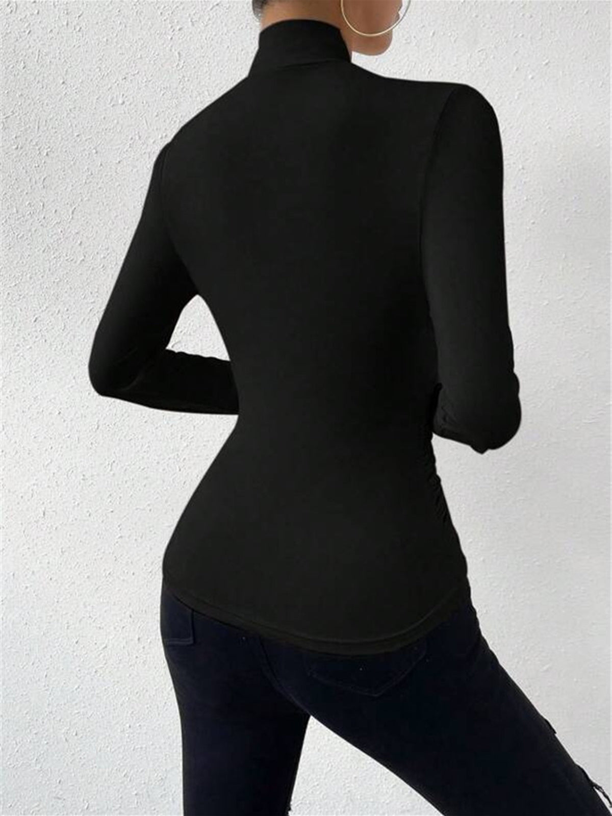 Black mock-neck long-sleeve top, back view with smooth fitted silhouette