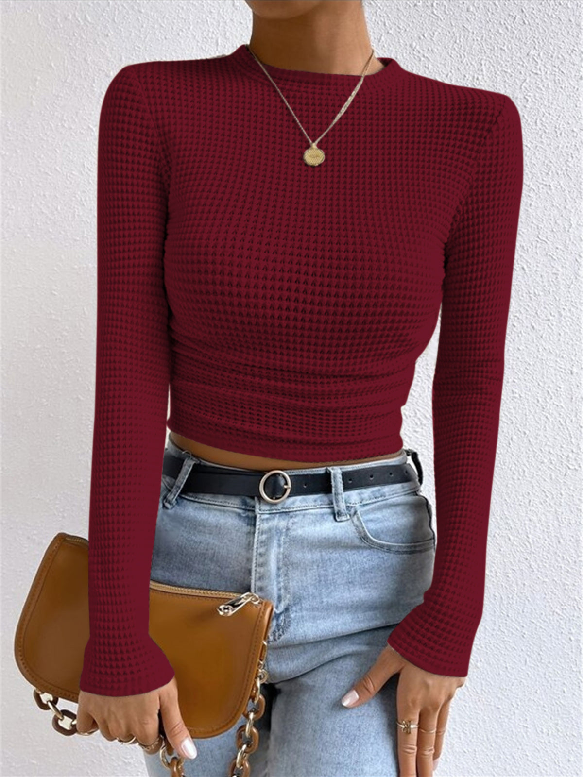 Burgundy waffle knit long-sleeve crop top with round neck and ruched hem