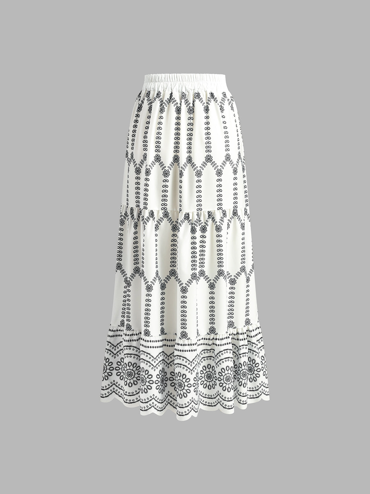 White maxi skirt with black vertical embroidery bands and floral lace border