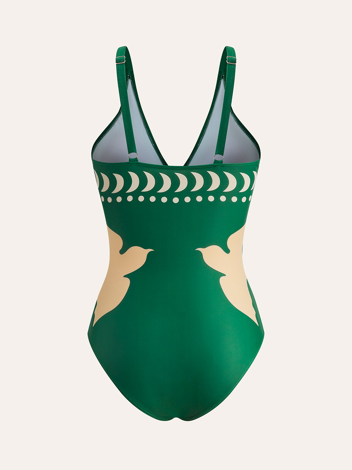 Women's one-piece swimsuit in dark green with thin straps and abstract bird crescent print