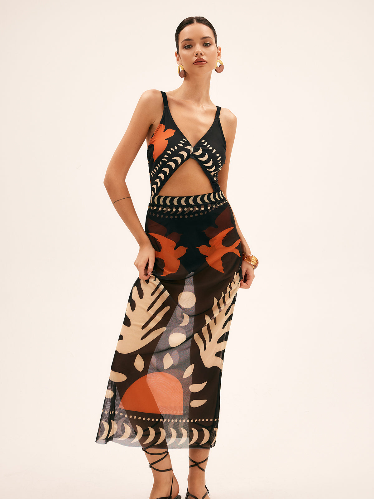 Sheer chiffon maxi skirt with black, orange, and beige tropical abstract print