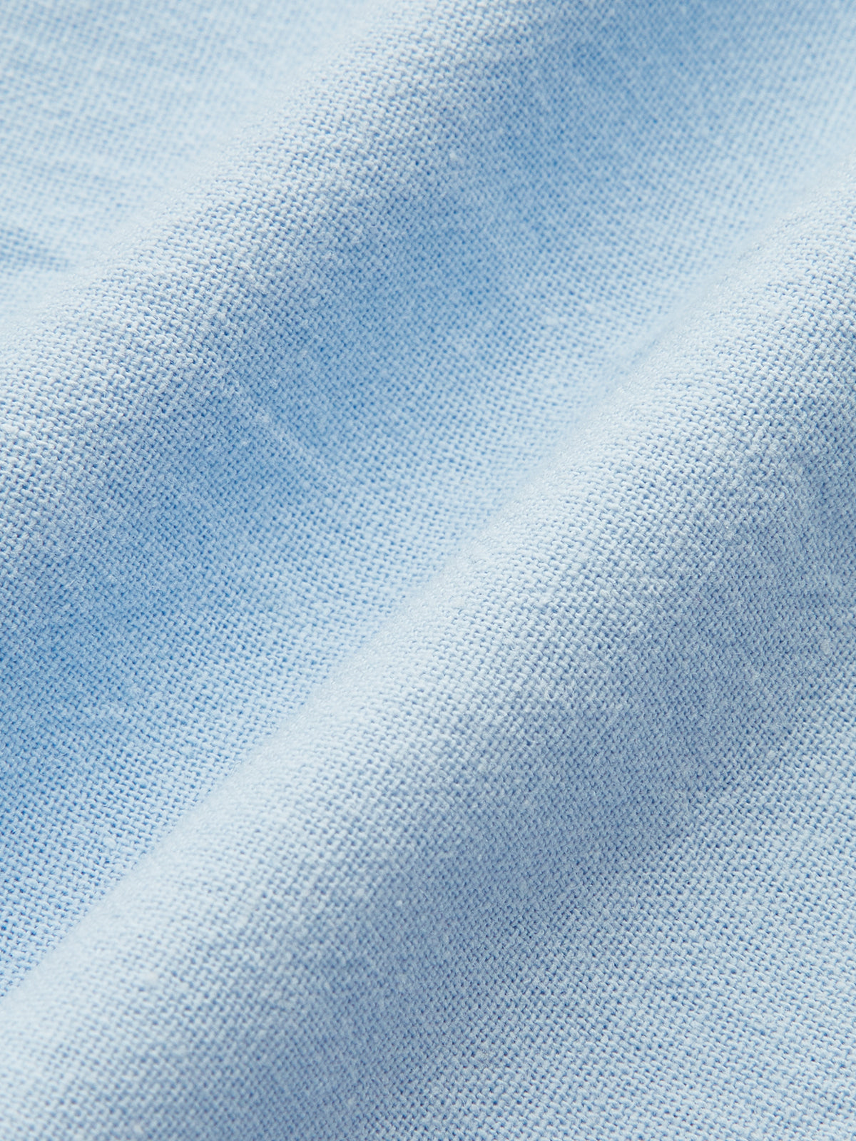 Light blue linen fabric close-up with woven texture