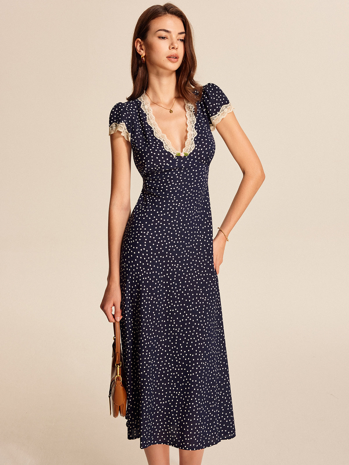 Navy satin polka-dot midi dress with lace-trim V neckline and cap sleeves