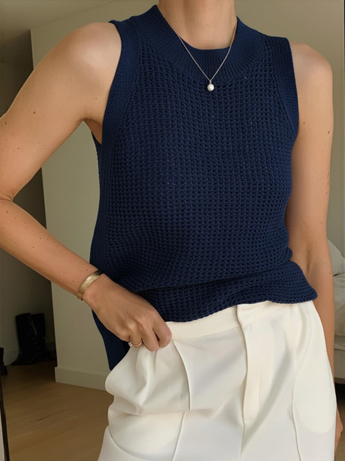 Navy open-knit cotton tank top with ribbed crew neck, sleeveless crochet texture