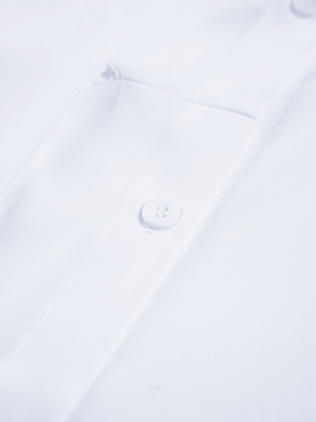 White cotton poplin shirt front with button detail near the collar