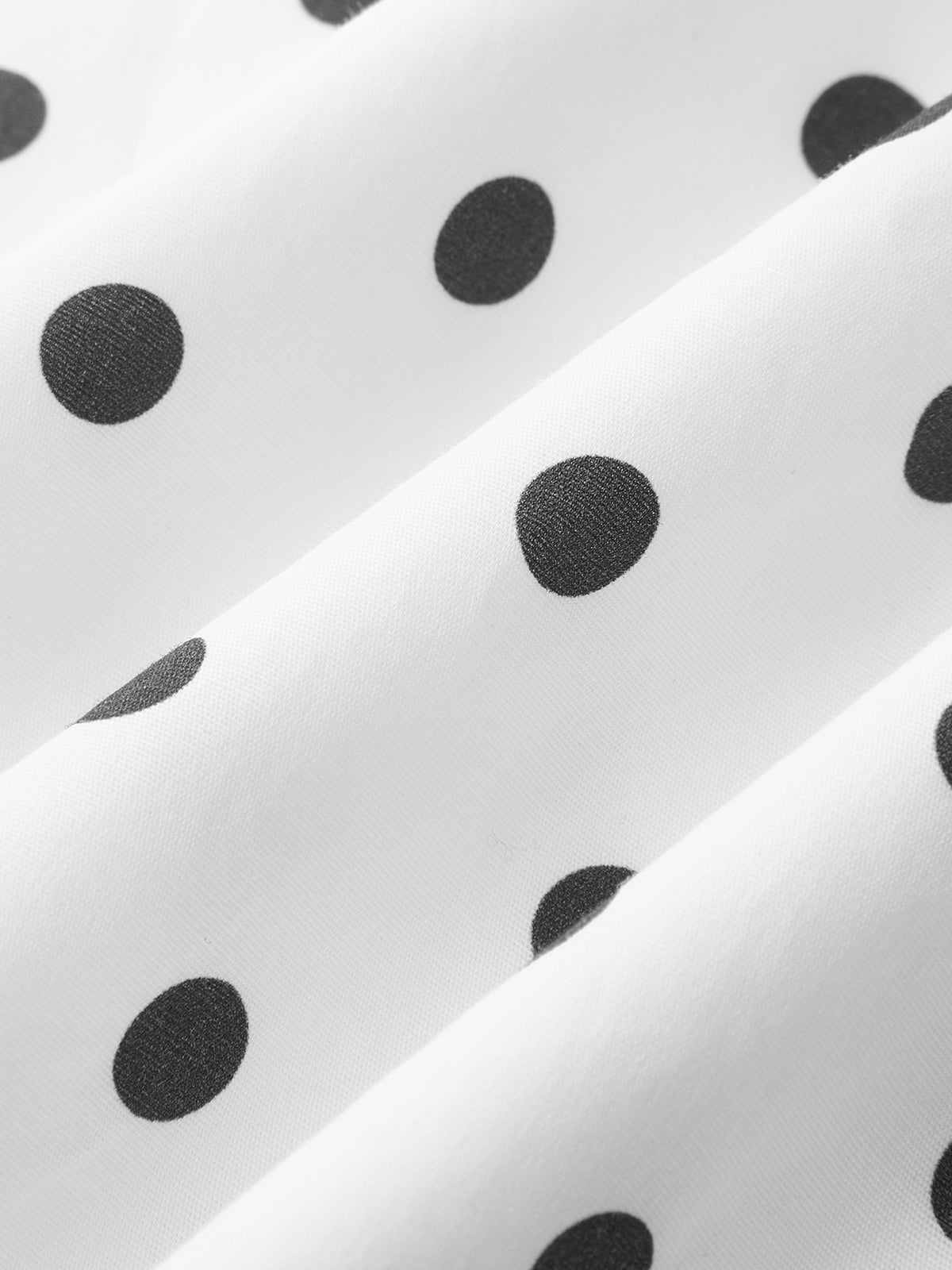White polka dot cami fabric texture close-up, showing allover dot pattern