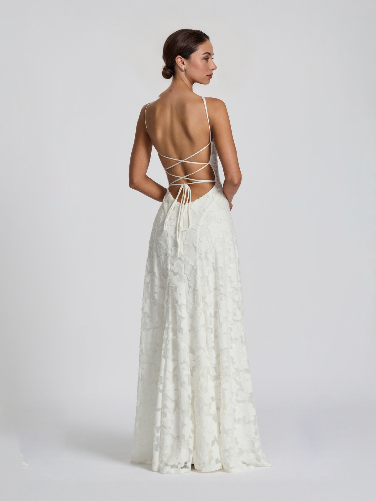 White satin spaghetti-strap maxi dress with open lace-up back and floral texture