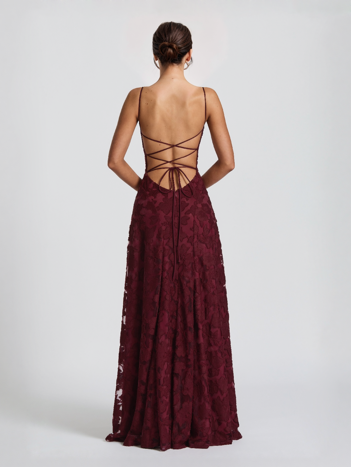 Maxi dress with spaghetti straps, open lace-up back, and burgundy floral lace overlay