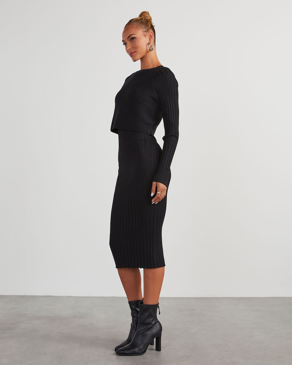 Black ribbed knit midi dress, long sleeves, fitted striped texture, side view