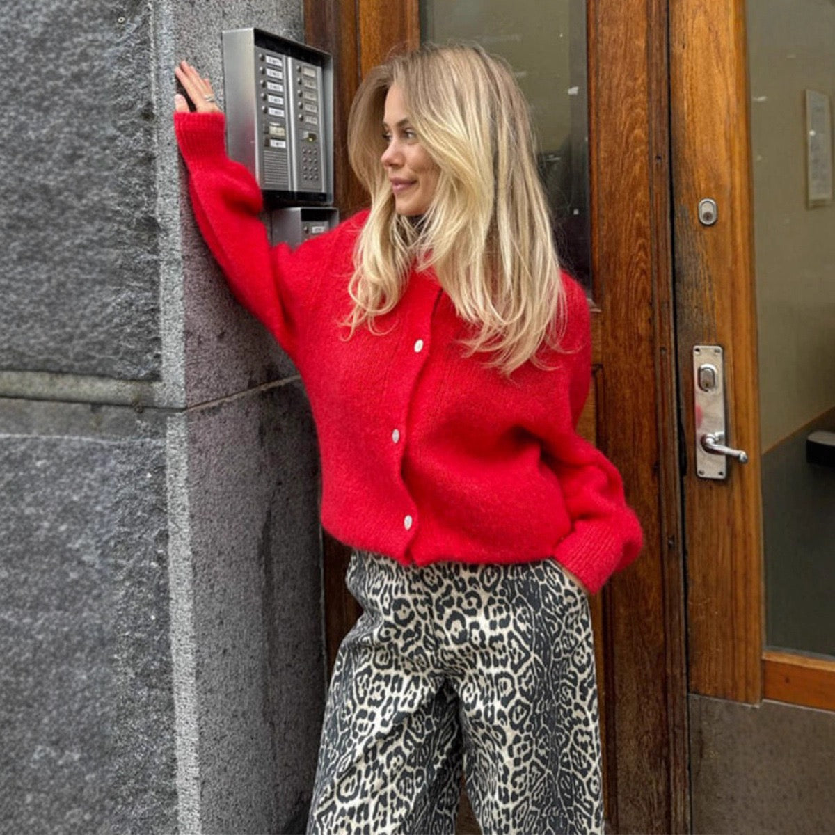 Red cropped button-front cardigan sweater with round neckline and long sleeves