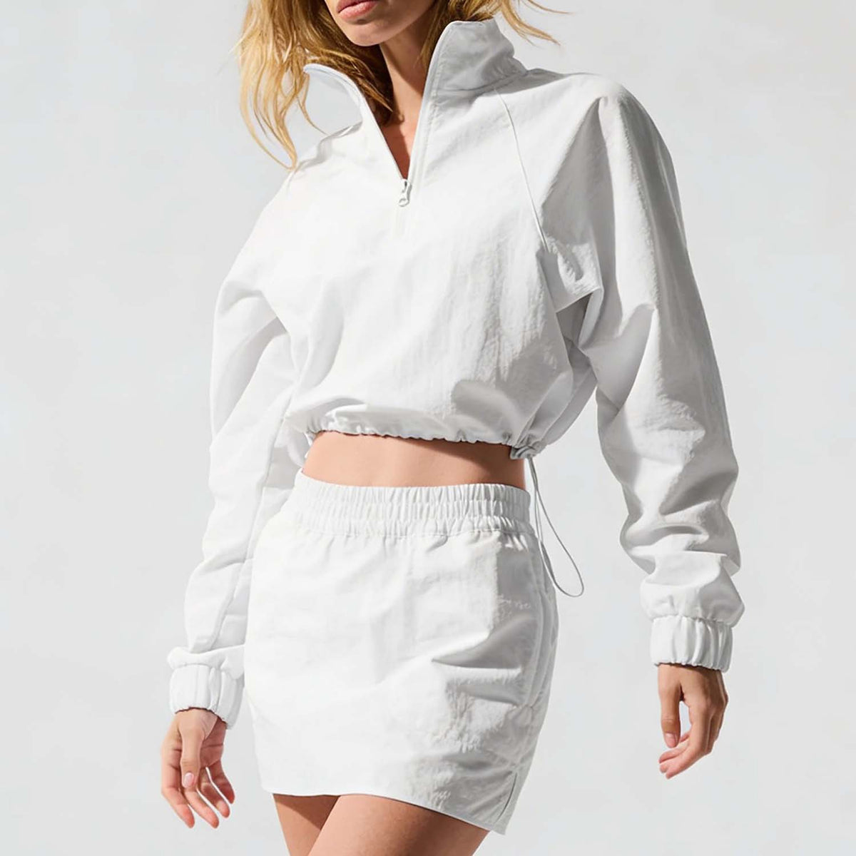 Women’s white half-zip cropped jacket and mini skirt set, front view