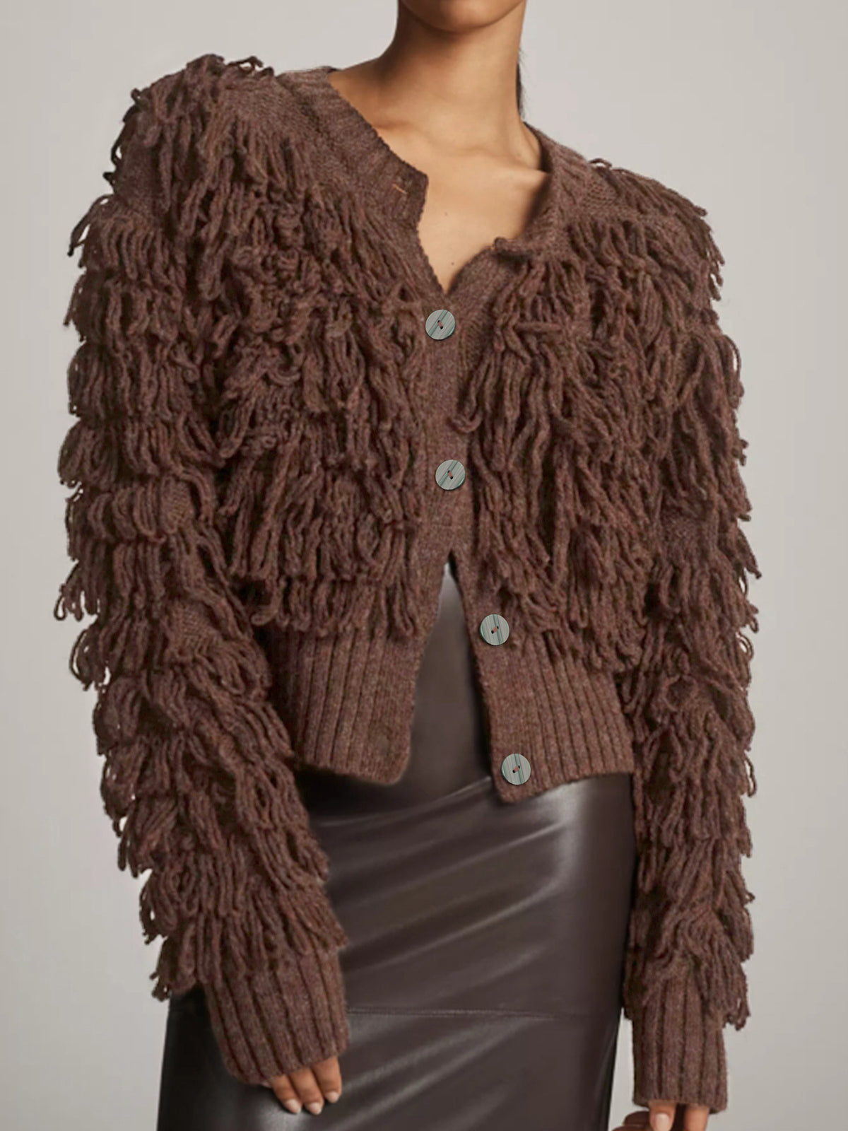Brown knitted jacket with long fringed sleeves and round button closure