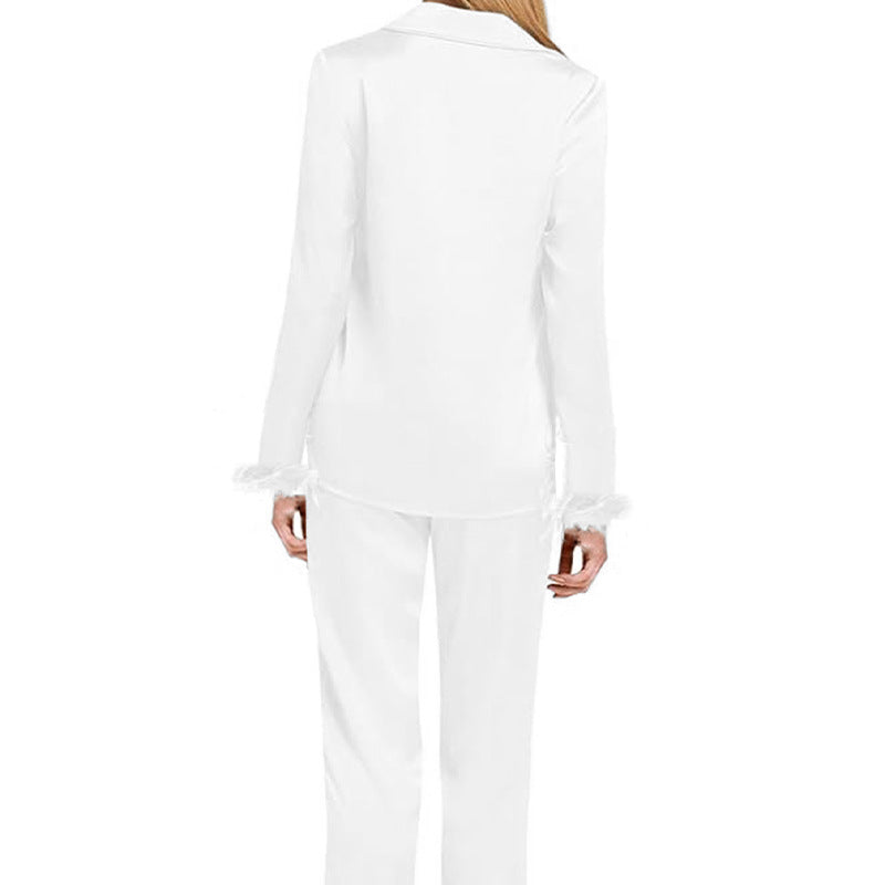 White long-sleeve pajama set with feather-trim cuffs and back button placket