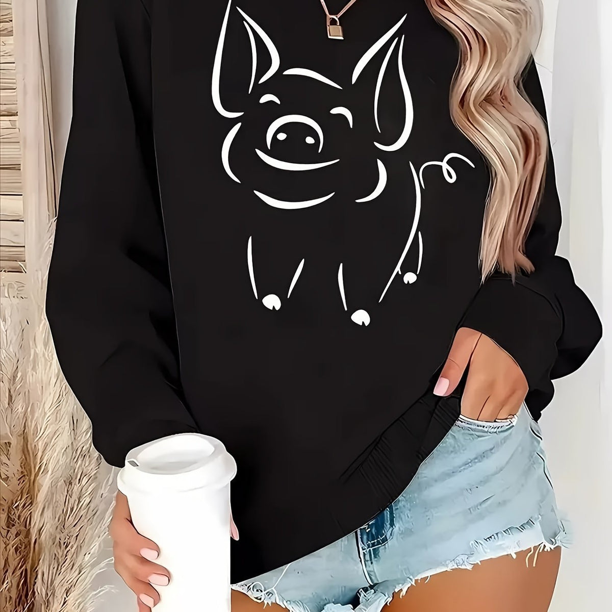Black women’s pullover hoodie featuring a smiling cat face front graphic