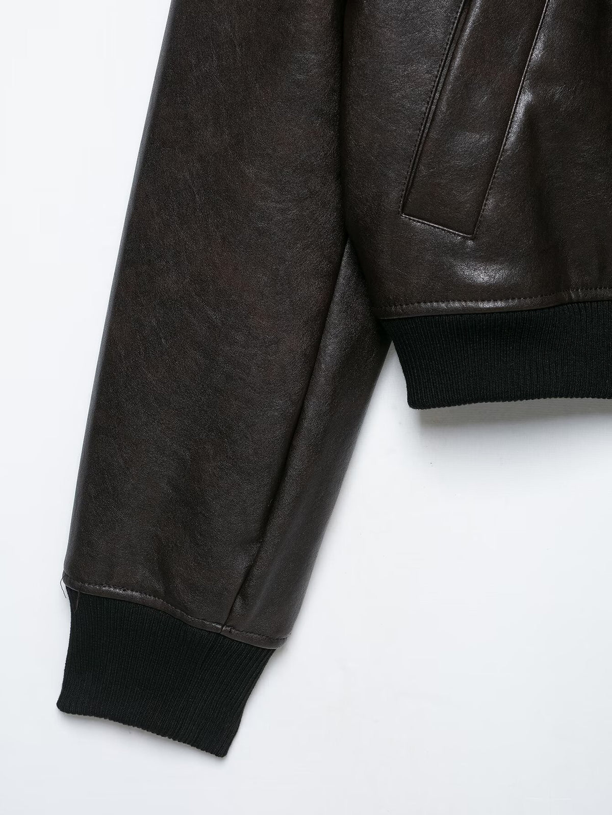 Close-up of the bomber jacket's sleeve, ribbed cuff, and pocket edge