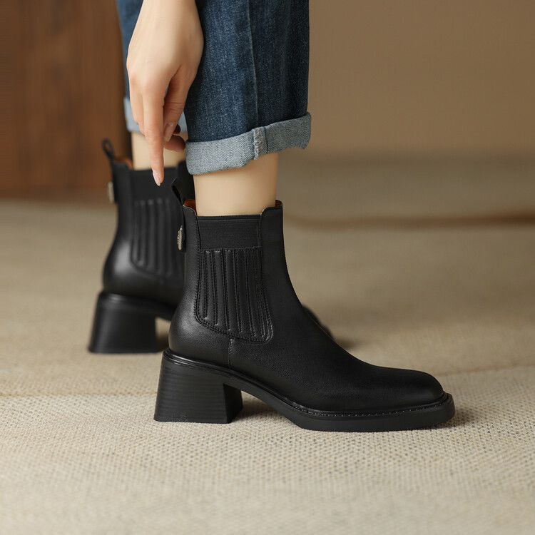 Women's black ankle boots with elastic side panels and chunky mid heel.