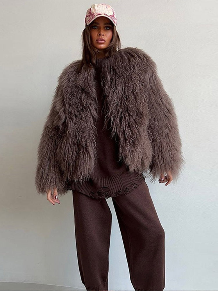 Brown short faux fur coat with long sleeves, shaggy fringe texture, front view