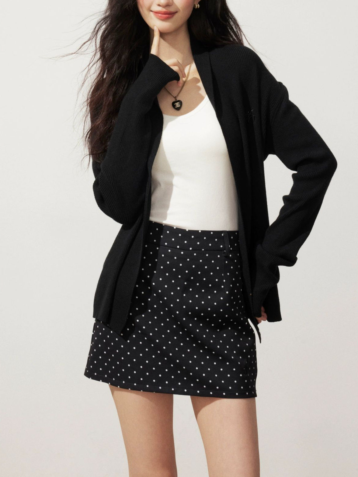 Black knitted cardigan sweater jacket with open front and long sleeves