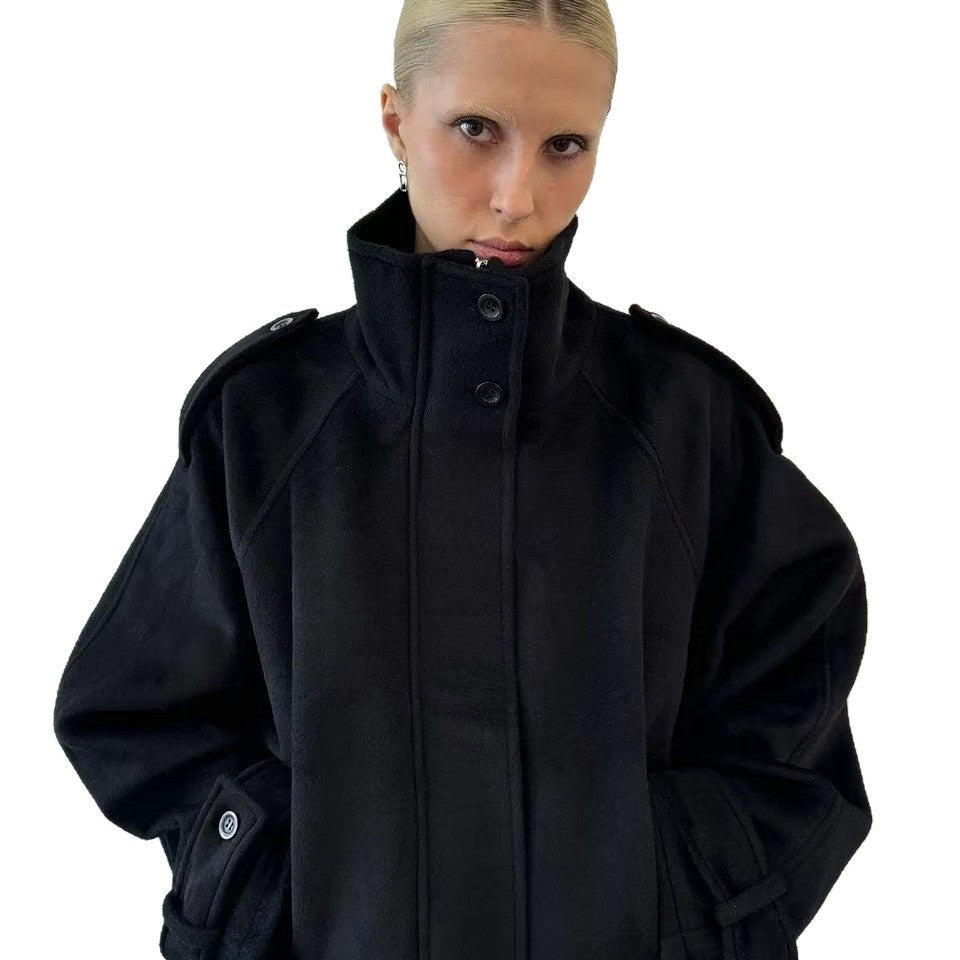 Black wool jacket with stand-up collar and snap buttons, oversized relaxed fit.