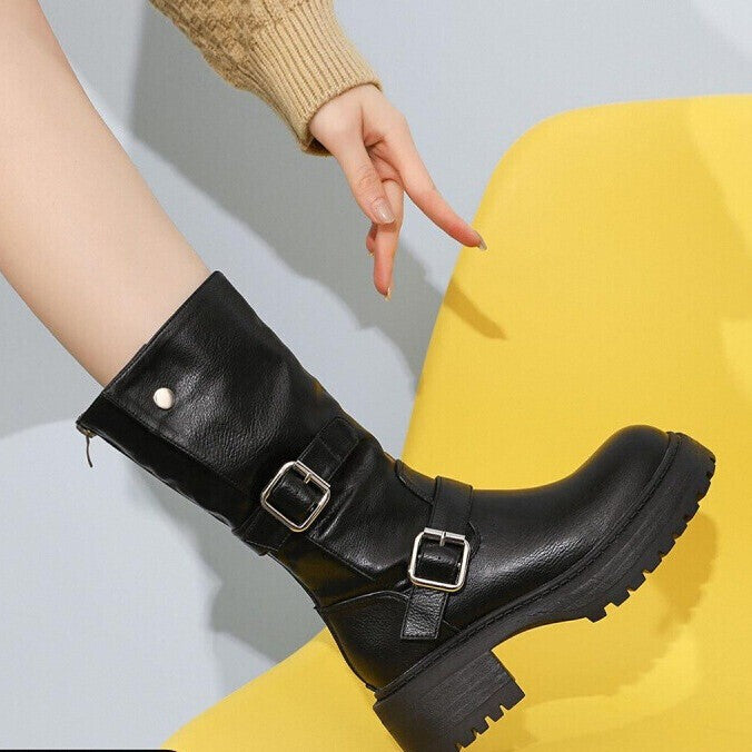 Black mid-calf western boots with two buckle straps and chunky lug sole.