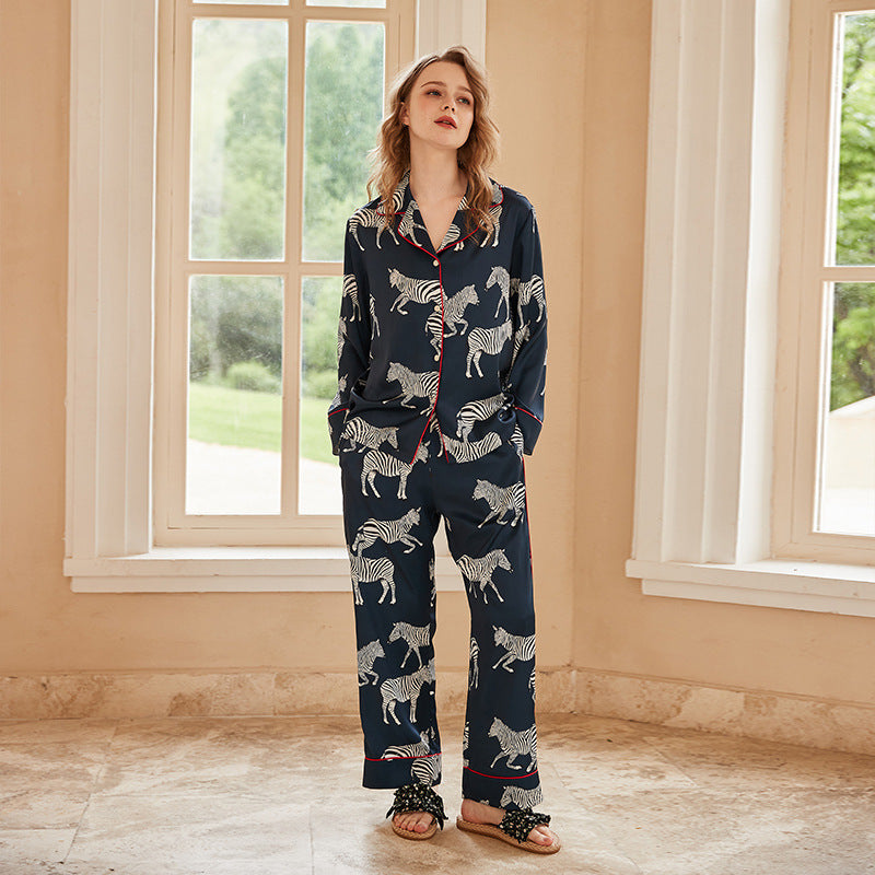 Navy women's pajama set with white zebra print: button-front long sleeves and pants