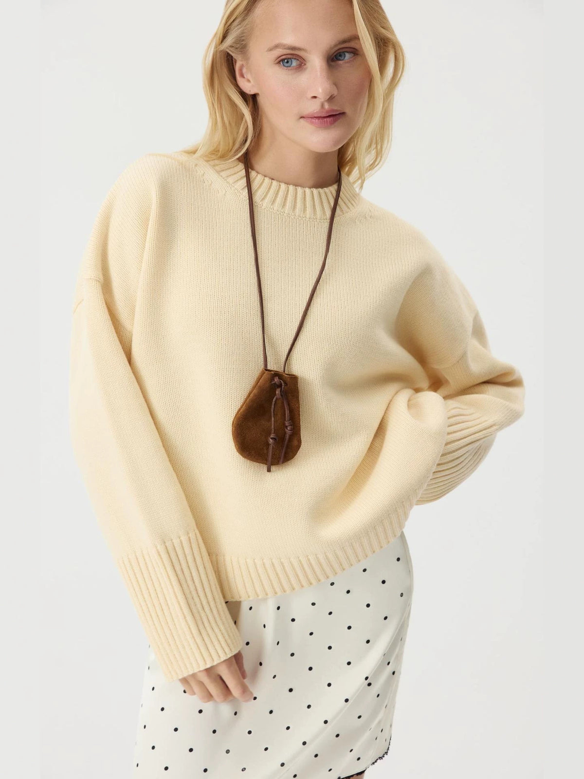 Women's beige knit sweater with crew neck and long sleeves, relaxed fit