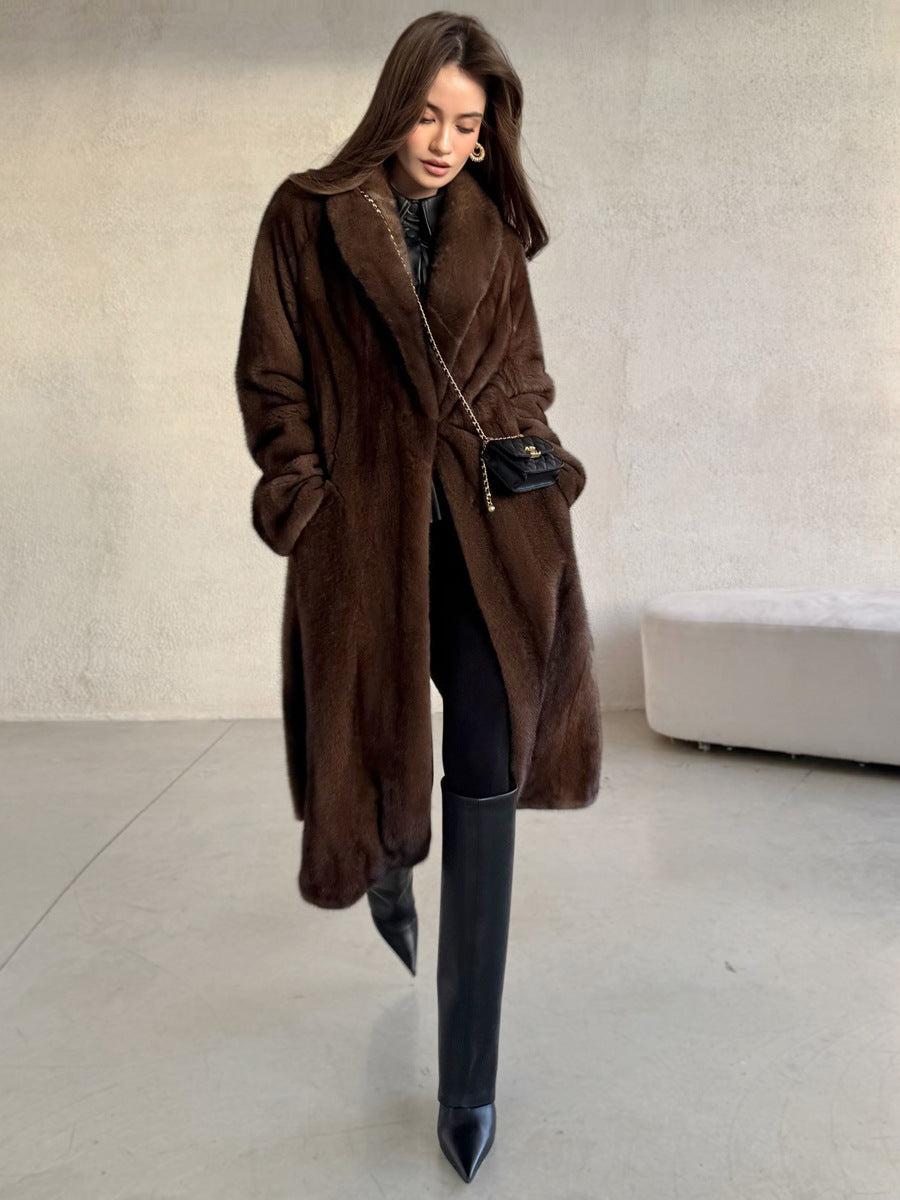 Dark brown long faux fur coat with open front and plush collar, standing pose