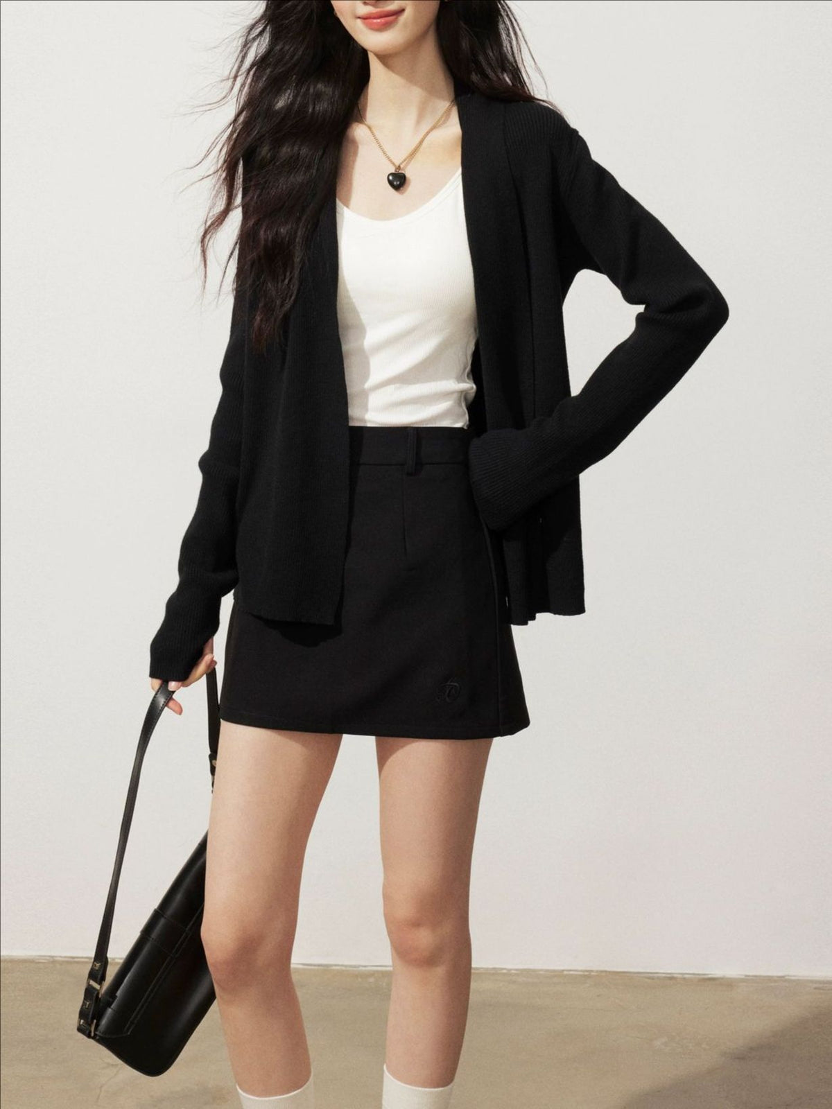 Black knitted cardigan sweater jacket, open front, long sleeves, hip-length