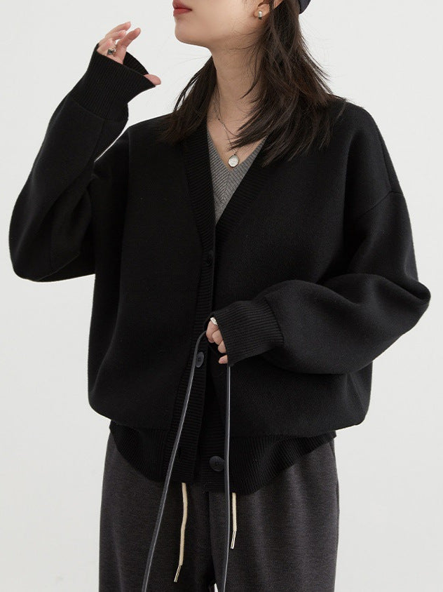 Black V-neck cardigan sweater with button front and ribbed hem, long sleeves