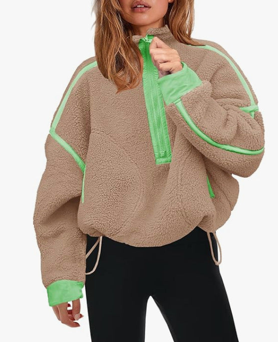 Beige plush zip sweatshirt with green zipper and contrast piping at cuffs and hem.