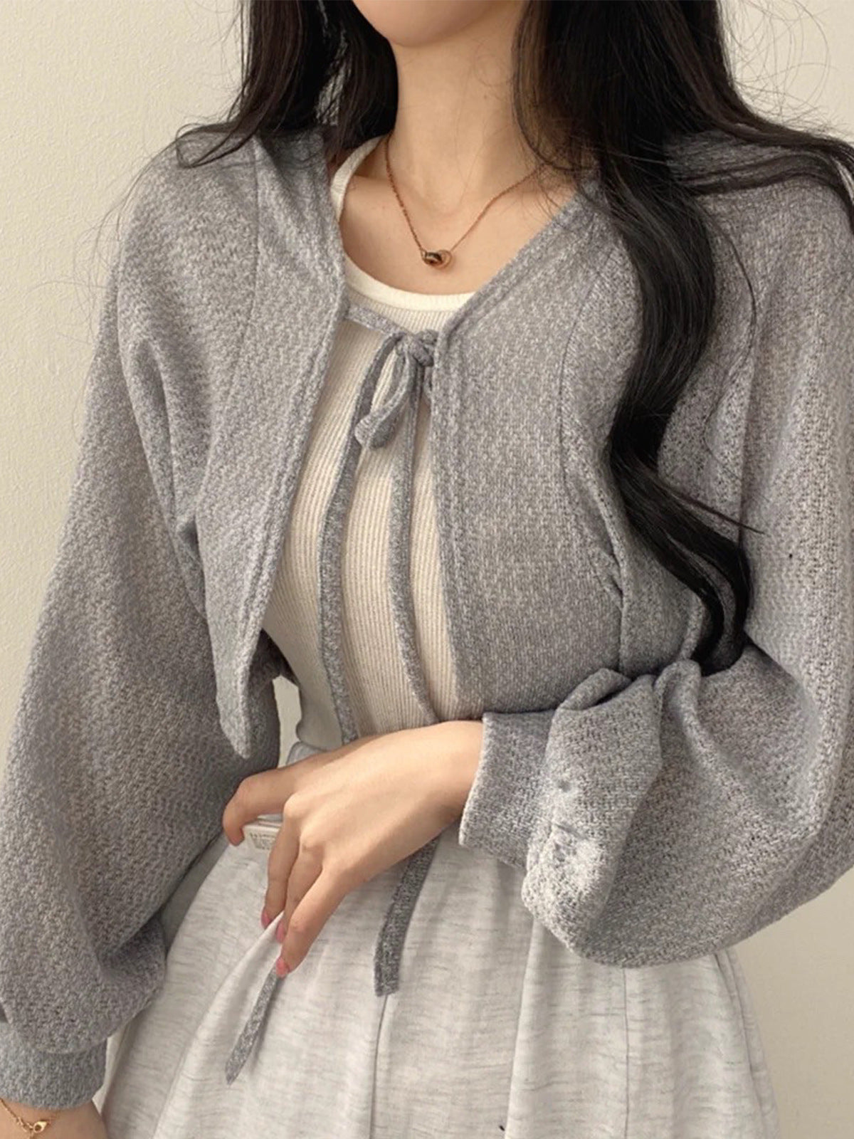 Gray cropped tie-front cardigan with long sleeves and bow neckline open knit bolero