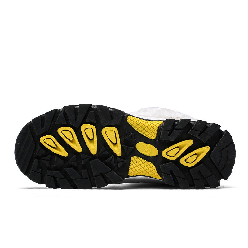 Black boot outsole with yellow tread pattern and rugged grip lugs