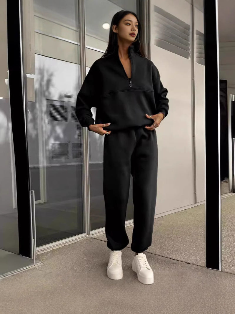 Black zip-lapel two-piece tracksuit set with quarter-zip pullover and wide jogger pants