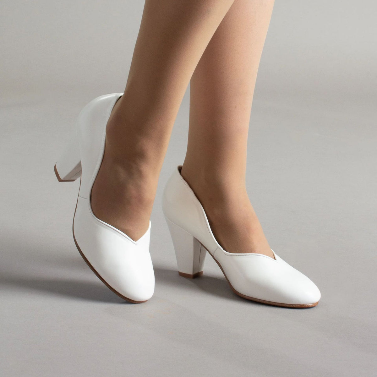 White women's pumps with rounded toes and chunky block heels