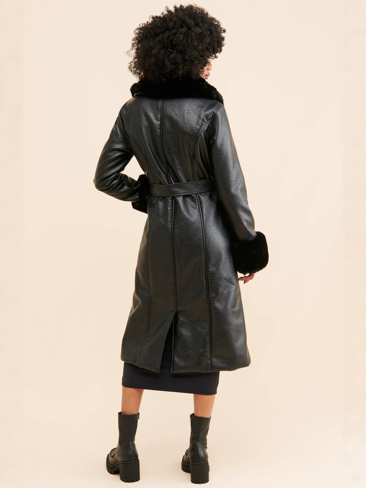 Black long coat back view, faux fur collar with leather-look panels and belt