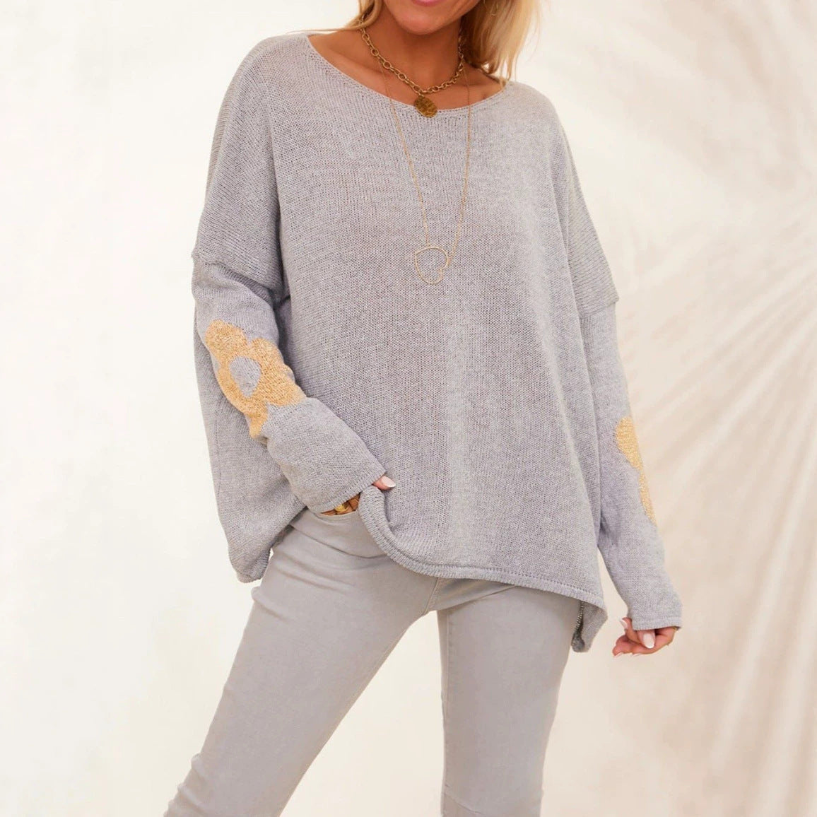 Light gray floral jacquard pullover sweater, round neck, loose fit, long sleeves.