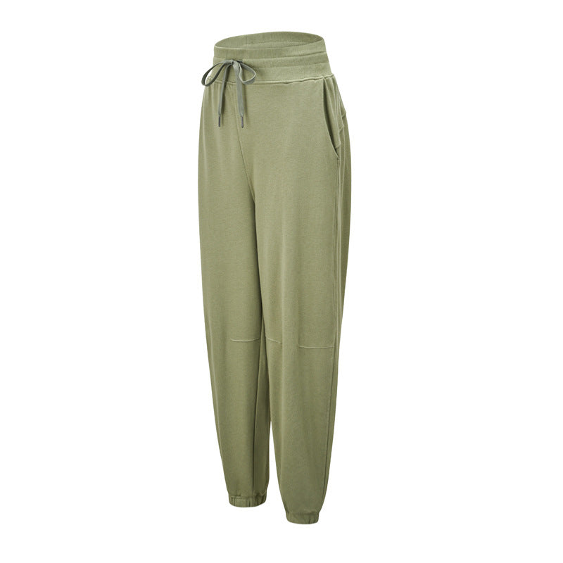 Olive jogger pants with a wide drawstring waistband, side pockets, and cuffed hems